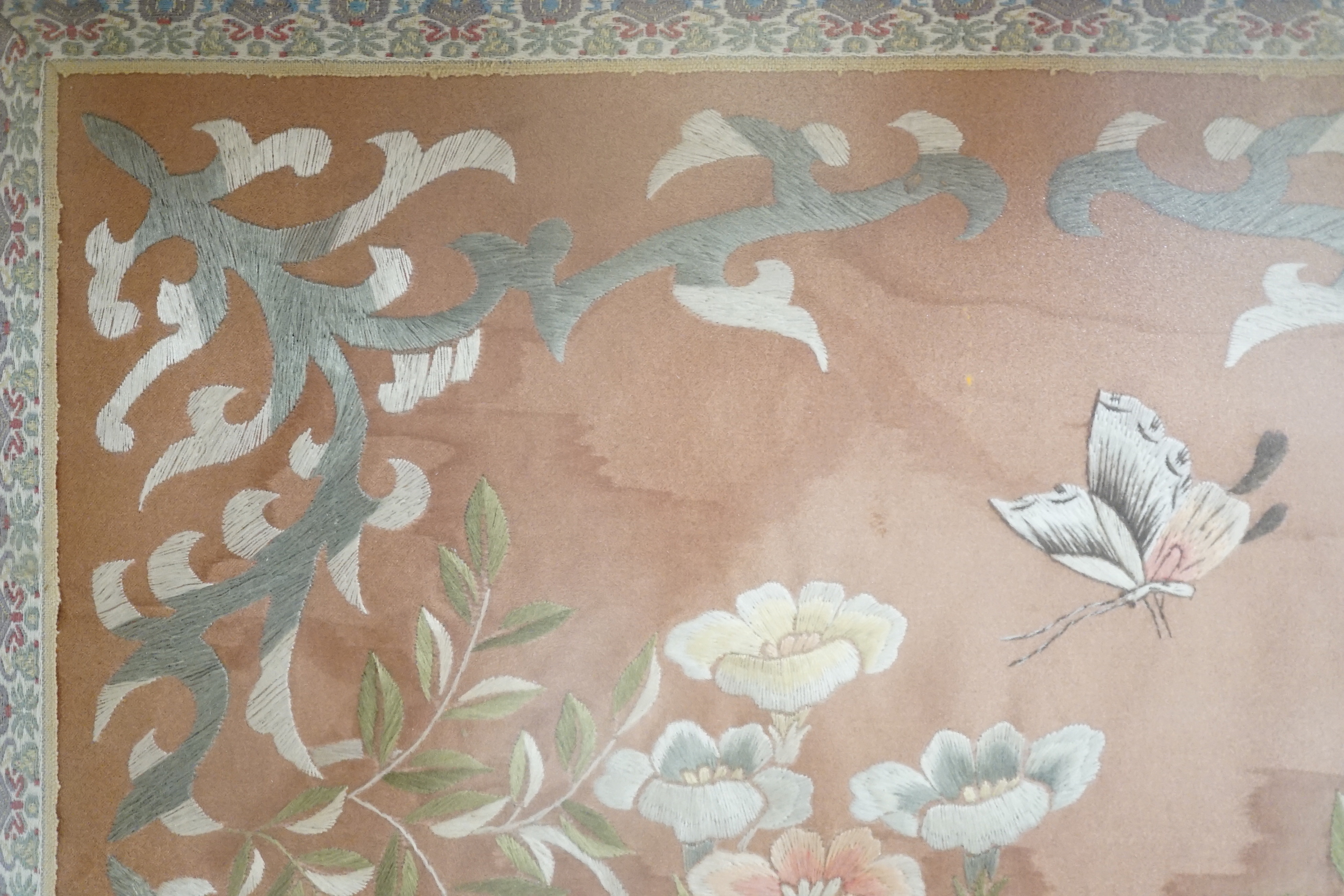 A Chinese silk panel embroidered with flowers and butterflies, framed, 43cm x 38cm